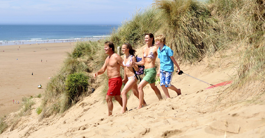Family walking down dunes